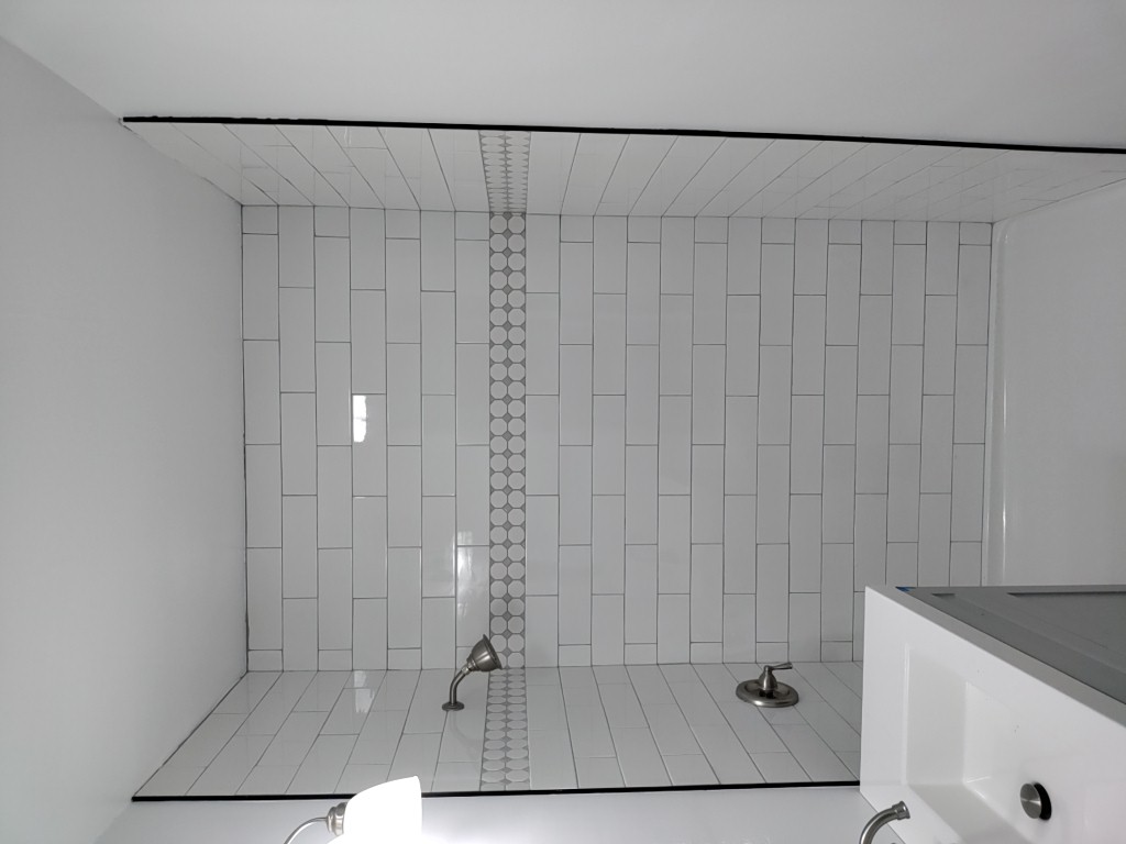 Finished white tile shower remodel in Utah bathroom