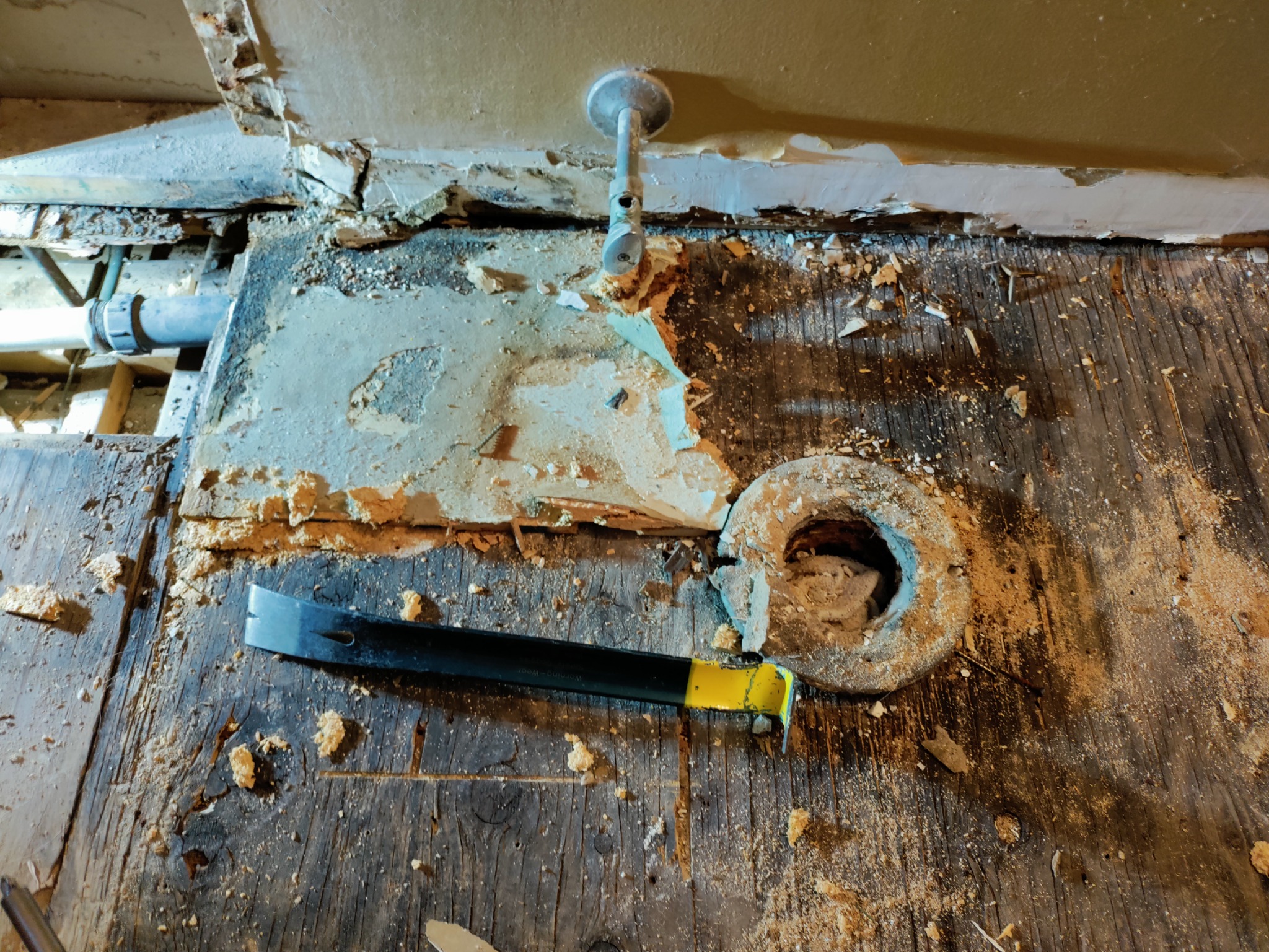Rotted bathroom subfloor around toilet flange after tile removal in Utah bathroom remodel