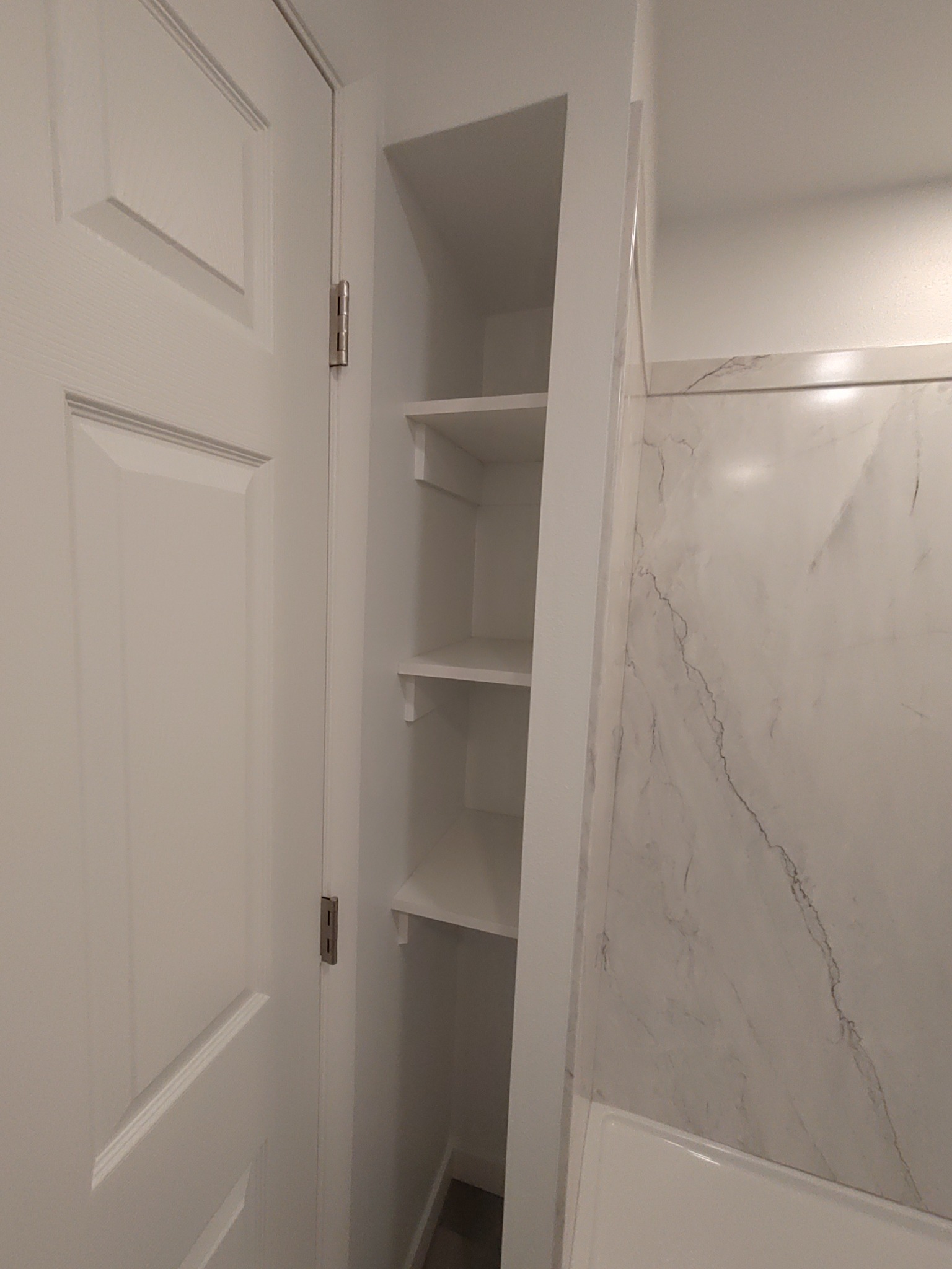 Sentrel shower wall detail and bathroom storage shelves in Utah remodel