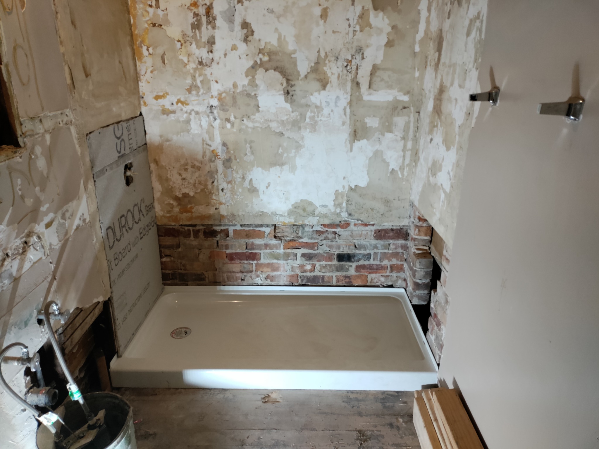 Shower pan set during Utah shower remodel wall rebuild
