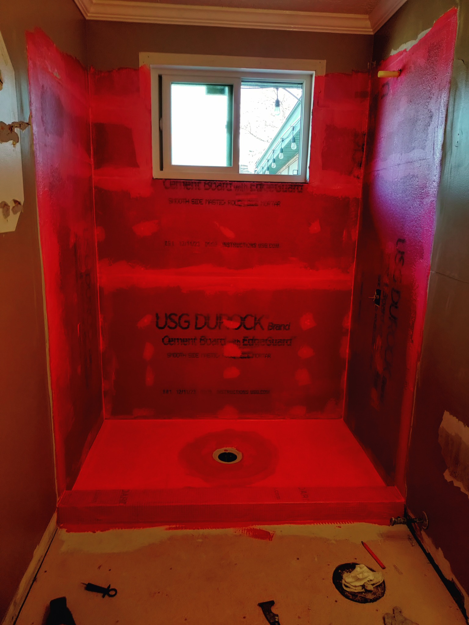 Red waterproofing membrane over Durock cement board in Utah shower remodel