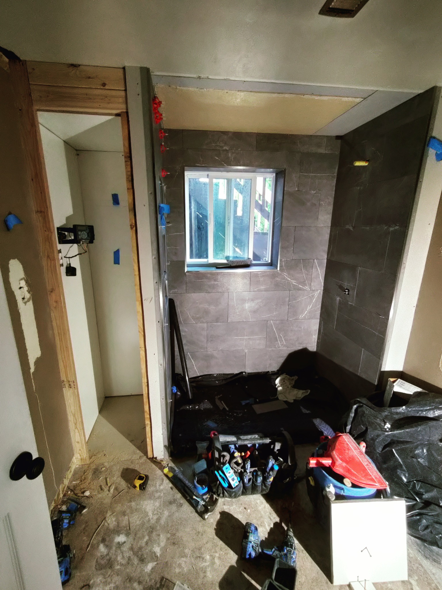 Walk-in shower tile progress with large format tile in Utah bathroom remodel