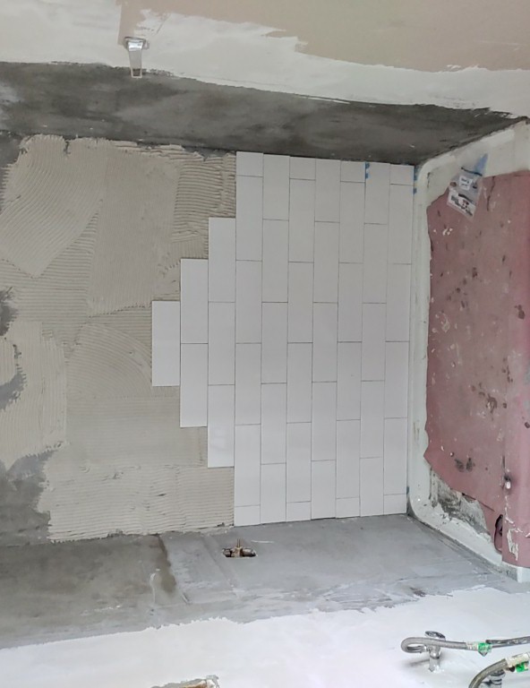 White subway tile shower installation in progress in Utah bathroom remodel