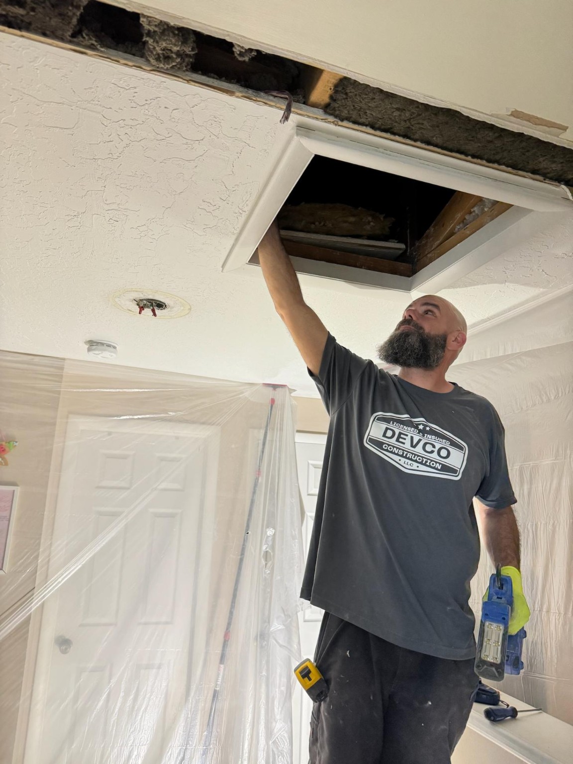 Brian from Devco preparing a protected work area during a bathroom remodel