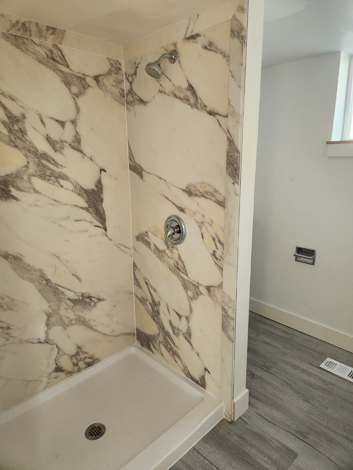 Bathroom after white marble-look shower wall panel installation