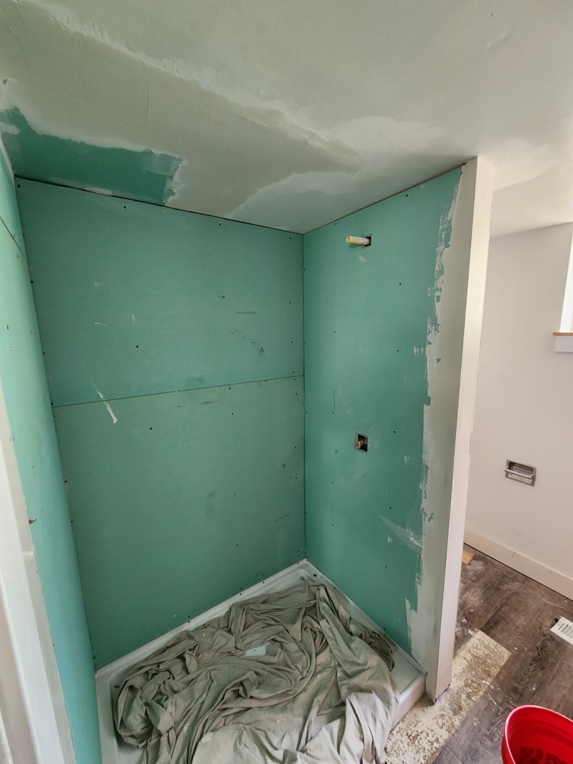 Bathroom shower before finished wall panels with green board prep installed