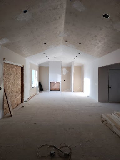 Open concept interior during whole home renovation with vaulted ceiling